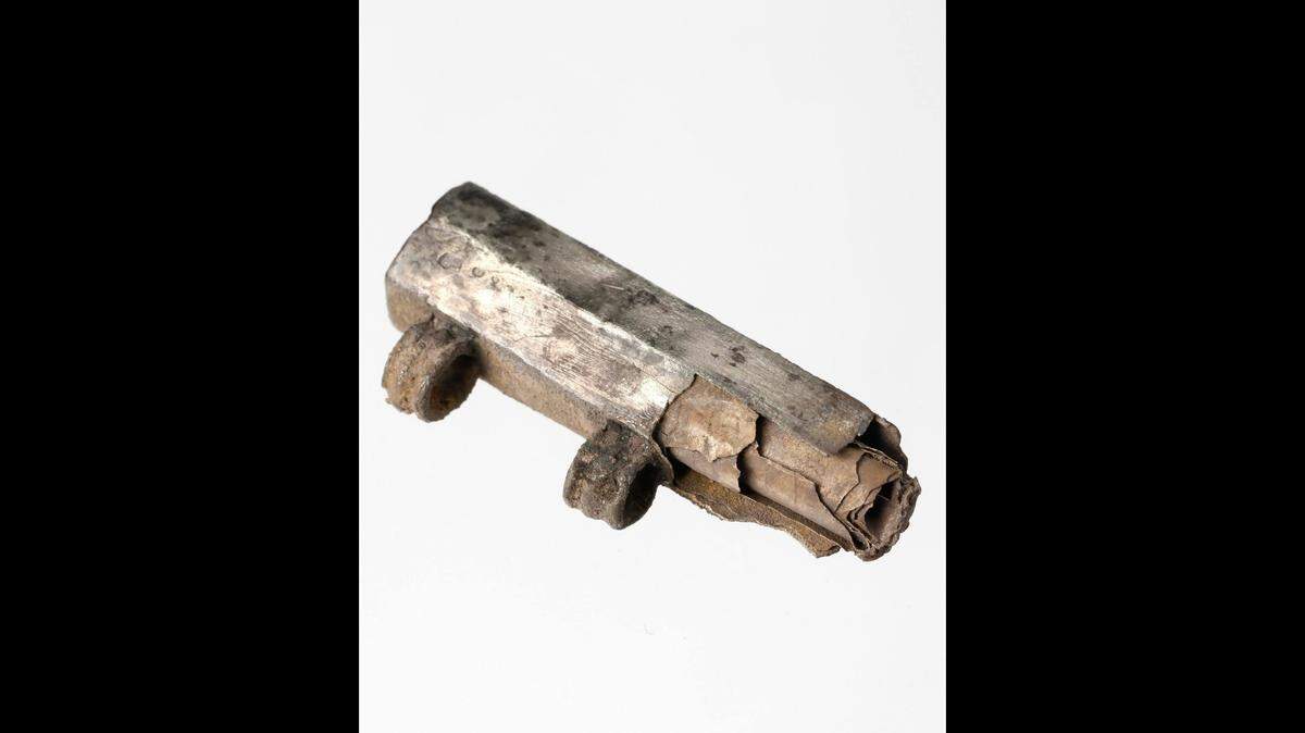 Archaeologists in Frankfurt, Germany, found a 1,750-year-old amulet with a silver scroll and inscription referencing Christianity, photos show.