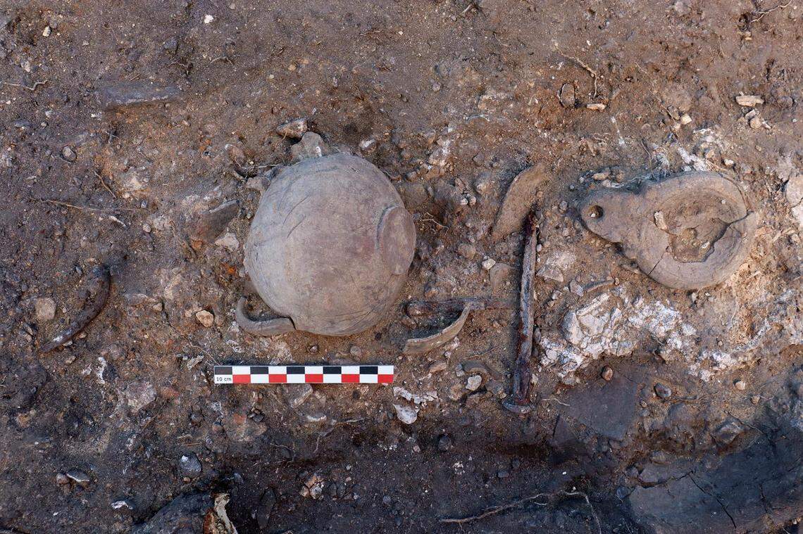An oil lamp and jug found on the 1,600-year-old funeral pyres.