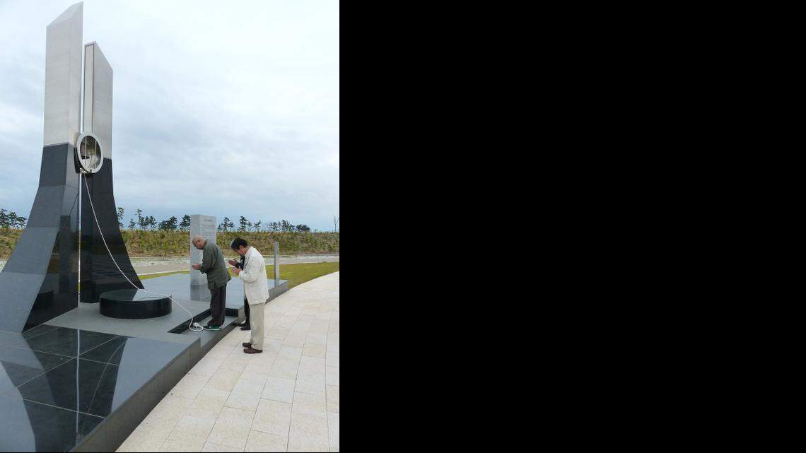 
PRAYER FOR VICTIMS: Zen priest Doryu Hioki and local officials pray at a memorial park commemorating tsunami victims.

