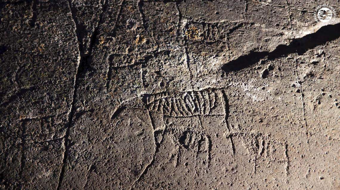 A close-up photo shows some of the ancient rock art.