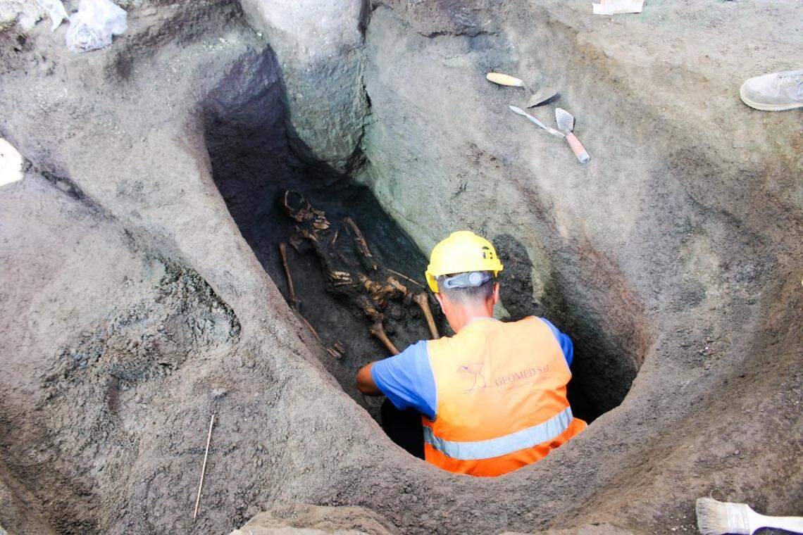An archaeologist excavates one of the 2,000-year-old burials.