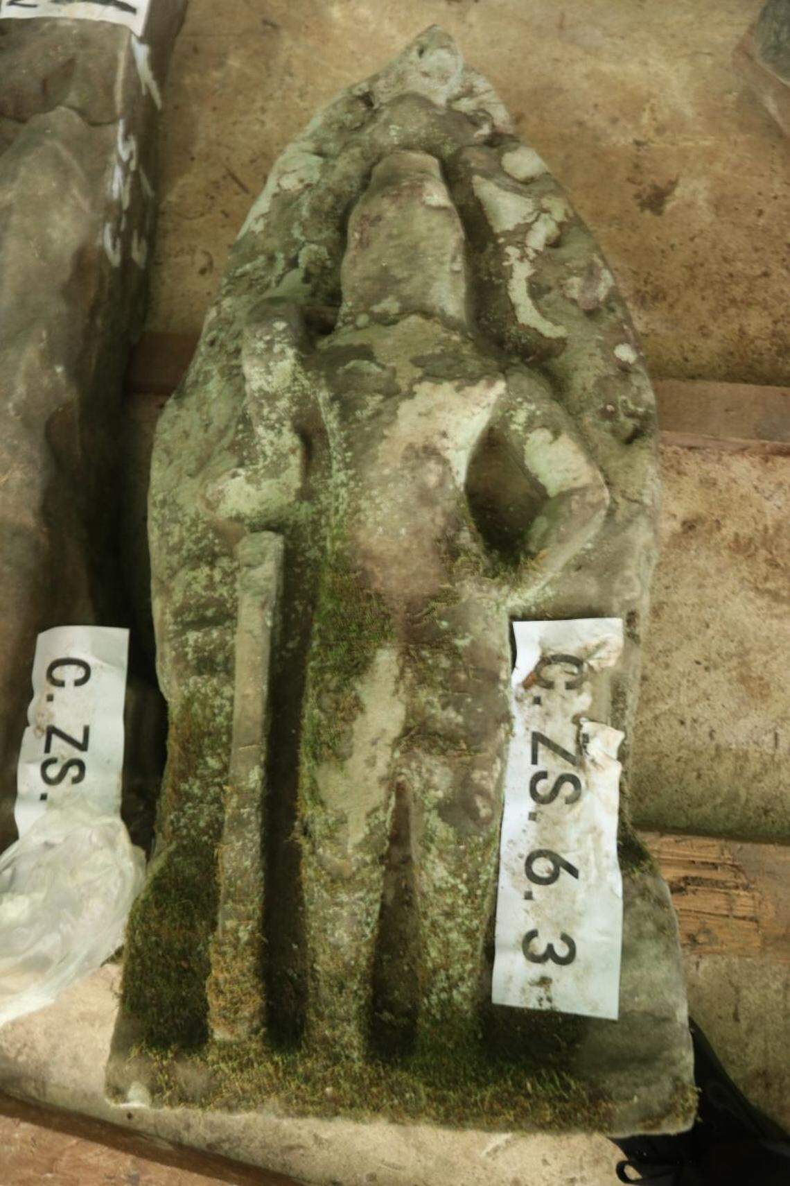 A 900-year-old guardian statue covered in moss.