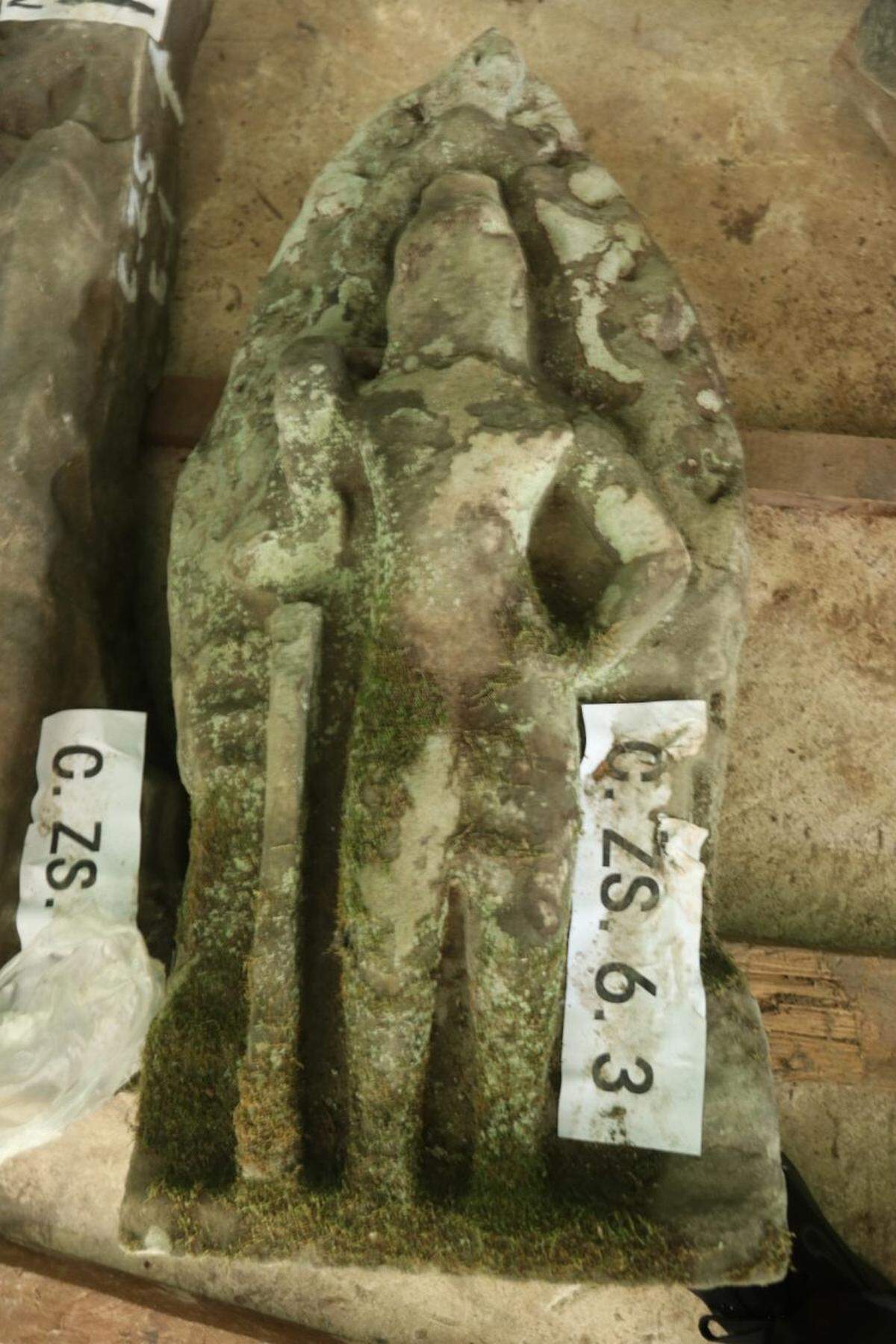 A 900-year-old guardian statue covered in moss.