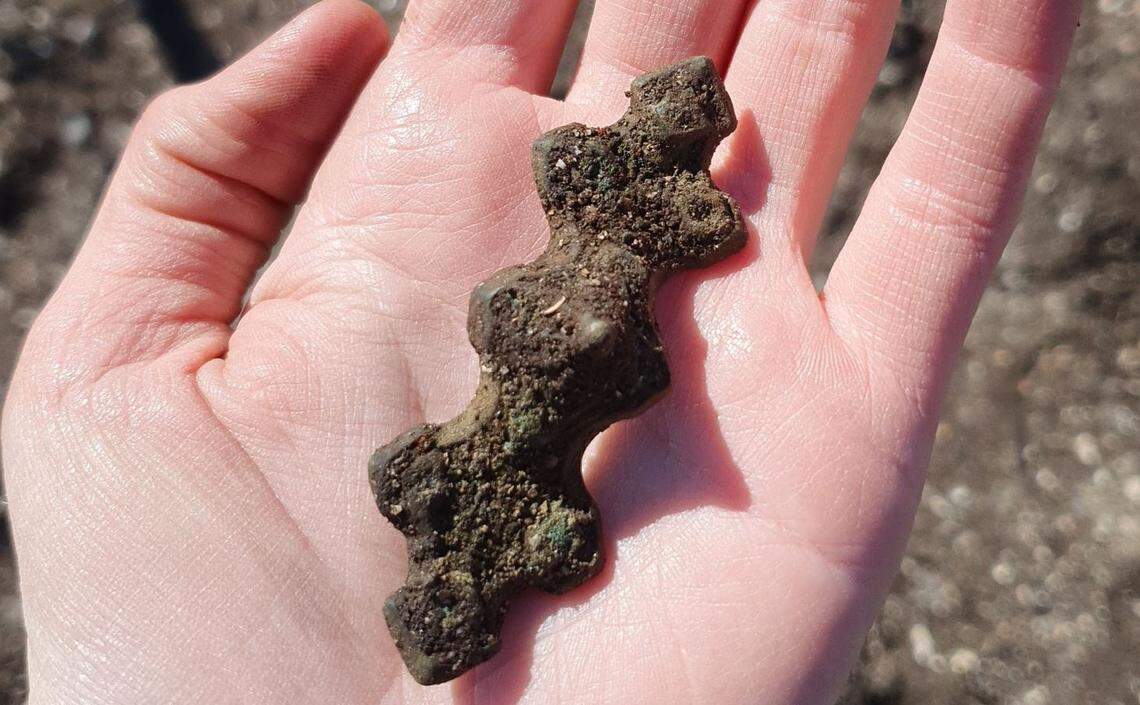 A Viking-era buckle, similar to a modern-day safety pin, found in the field.