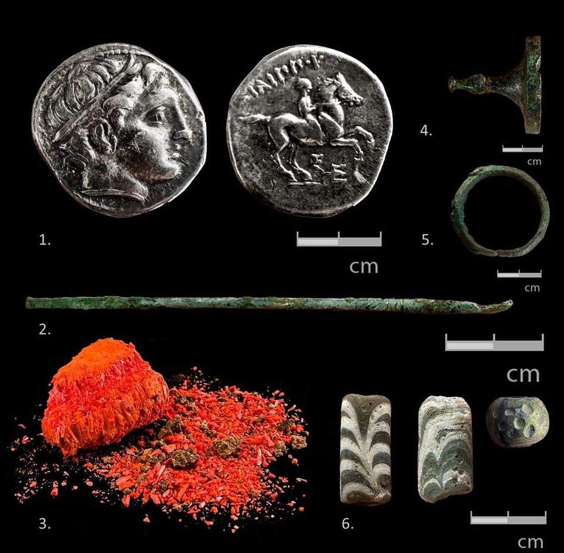 Other finds from the 2,400-year-old tomb including coins (1), metal items (2, 4, 5), bread crumbs (3) and glass beads (6).