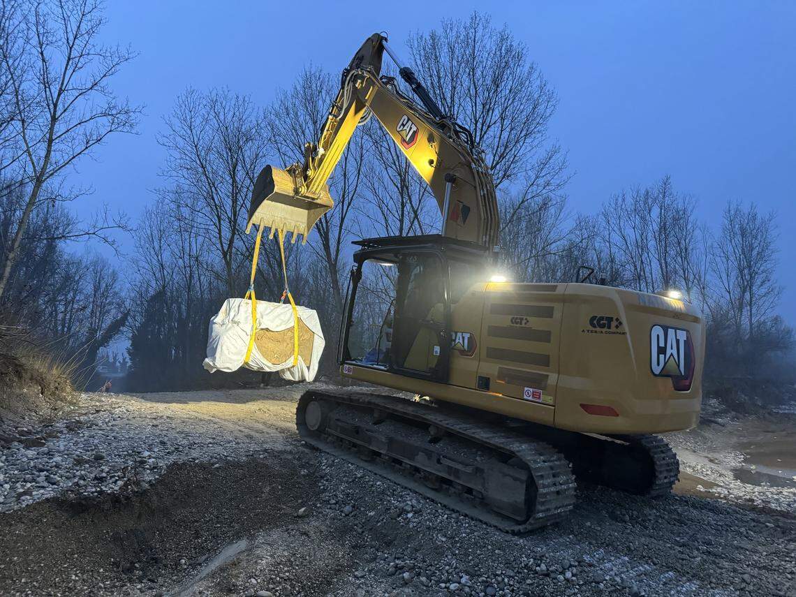 A construction vehicle moves the ancient Roman artifact.