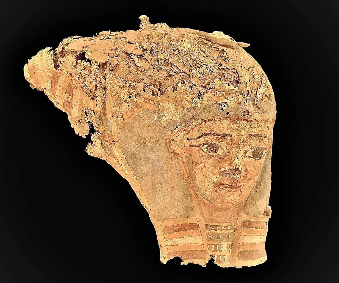An artifact with the face of a mummy found at the ancient cemetery.