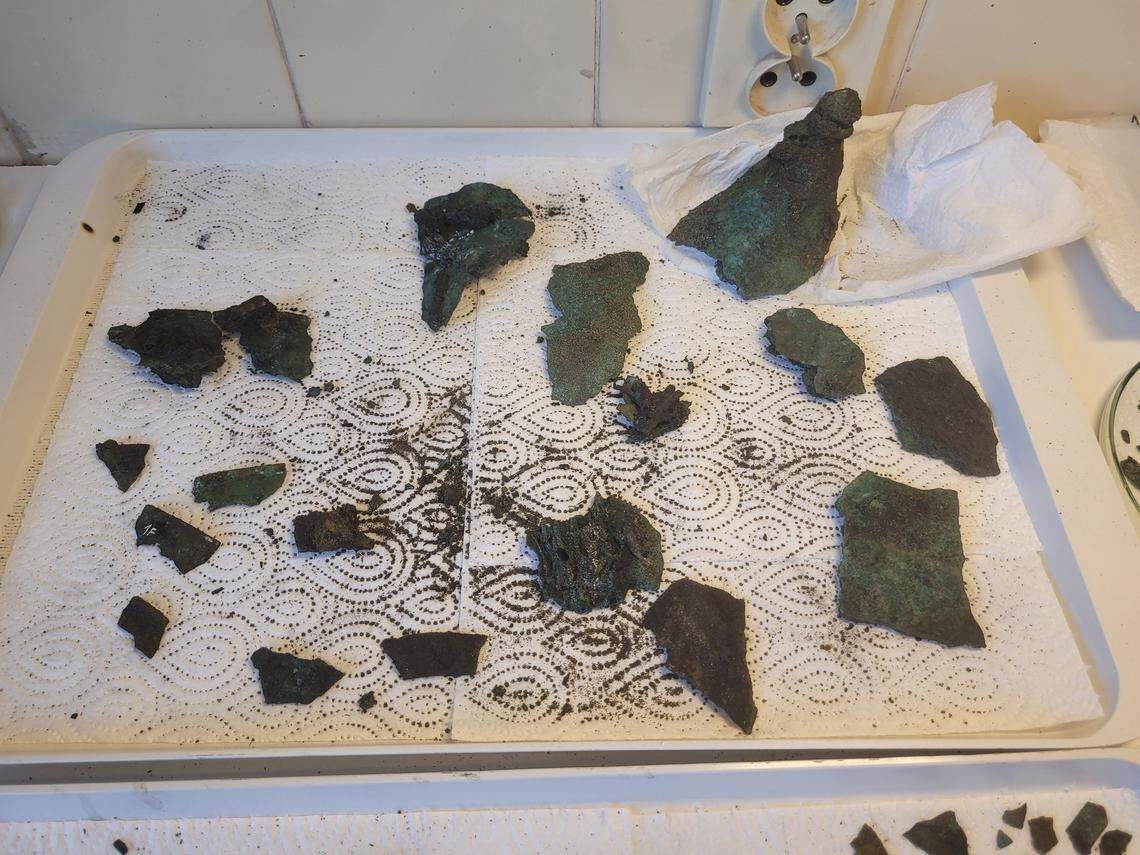 Fragments of the 2,300-year-old helmet after being removed.