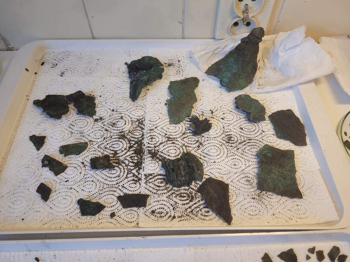 Fragments of the 2,300-year-old helmet after being removed.