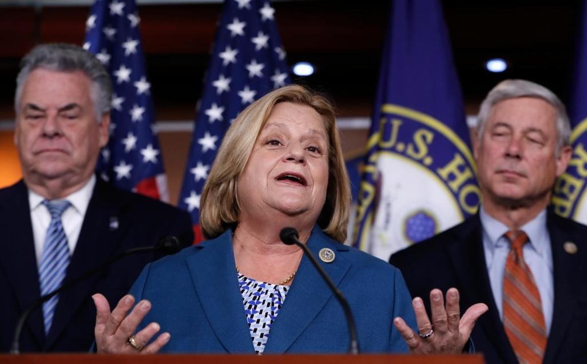 Rep. Ileana Ros-Lehtinen, R-Fla., is flanked by Rep. Peter King, R-N.Y., left, and Rep. Fred Upton, R-Mich., on Capitol Hill in Washington, Nov. 9, 2017.