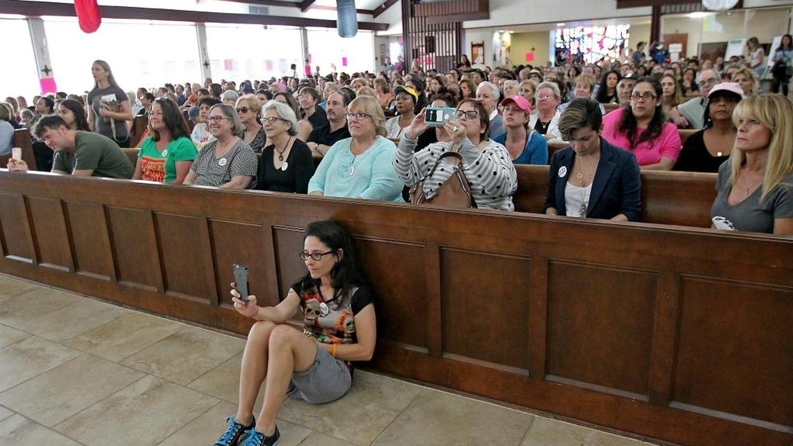 Jody Finver, in the foreground, of Coconut Grove takes pictures during an organizing meeting of anti-Trump activists last Sunday at St. Stephen’s Episcopal Church.