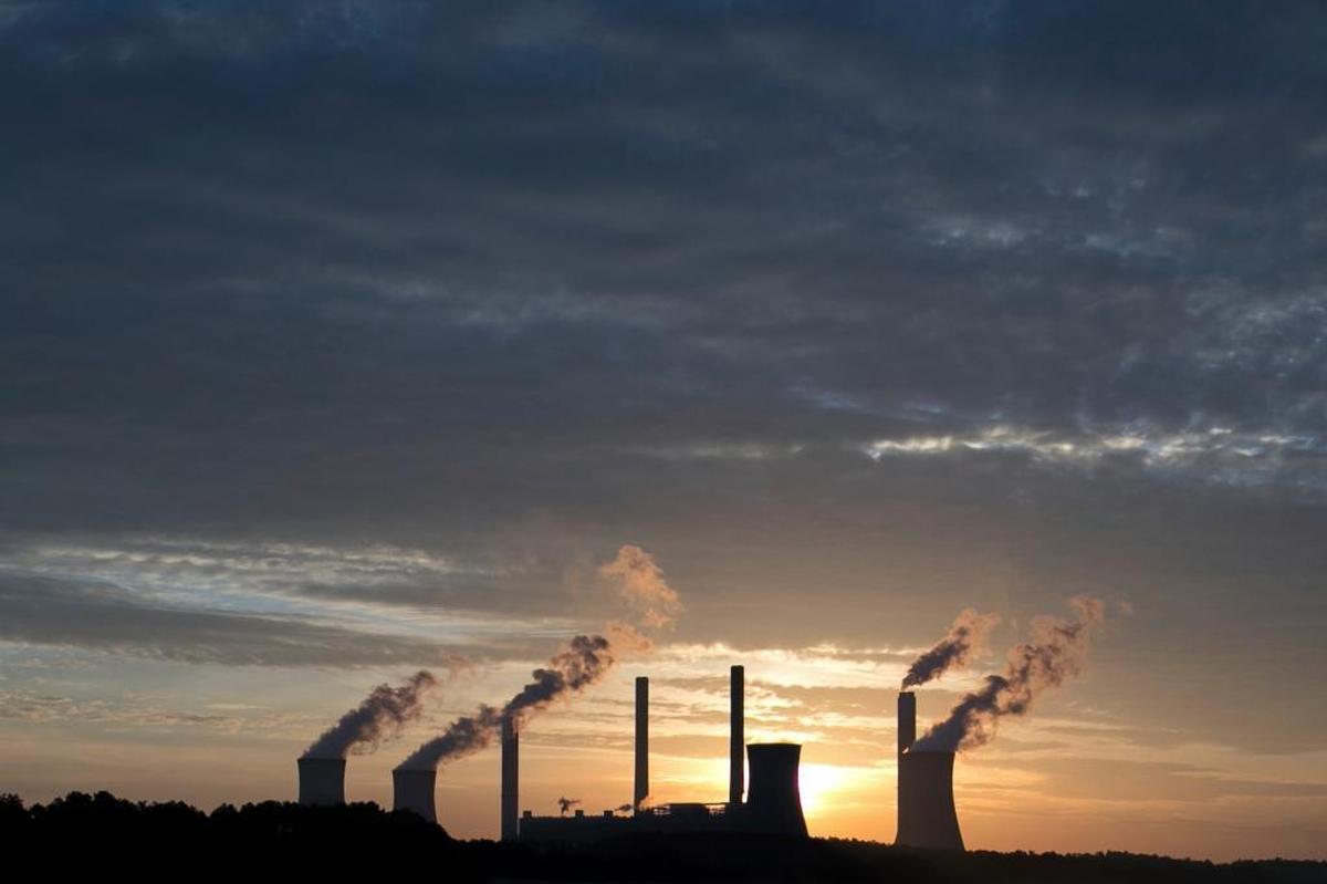 In this June 3, 2017, file photo, the coal-fired Plant Scherer, one of the nation's top carbon dioxide emitters, stands in the distance in Juliette, Ga. A new poll finds that less than a third of Americans support President Donald Trump’s decision to withdraw from the Paris climate accord.