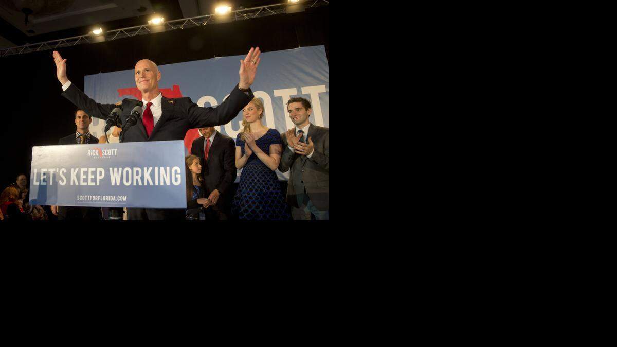 
Florida Gov. Rick Scott stands at the podium before making a victory speech after defeating Democratic challenger, former Republican, Charlie Crist, in Bonita Springs, Fla. on Tuesday, Nov. 4, 2014. 

