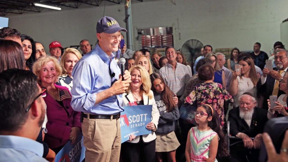 Florida Governor Rick Scott is surrounded by supporters as he visits Interstate Beverage Corp in Hialeah as part of his campaign rollout for the U.S. Senate on Tuesday, April 10, 2018.