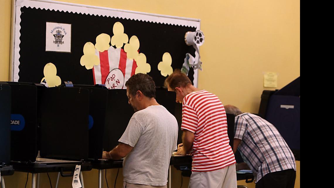 
From left, David Schlosberg, Peter Mehas, and Bernardo Duran vote in the Florida primary election at a precinct in the Morningside neighborhood of Miami, August 26, 2014.

