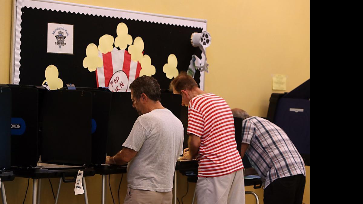 
From left, David Schlosberg, Peter Mehas, and Bernardo Duran vote in the Florida primary election at a precinct in the Morningside neighborhood of Miami, August 26, 2014.
