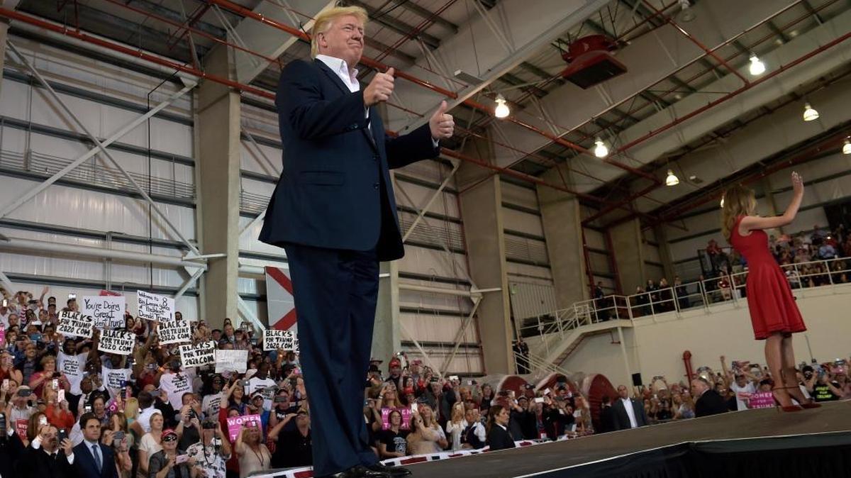 President Donald Trump and First Lady Melania Trump arrive for a rally at Orlando-Melbourne International Airport in Melbourne on Saturday.