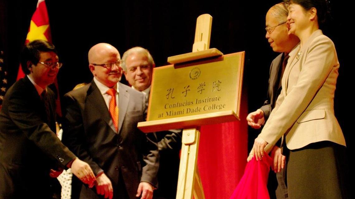 From left, Yongli Wang, Miami Dade College President Eduardo Padrón, professor Fangming Xu and Mme Yanping Gao, Chinese consul general, unveil the  Confucius Institute plaque during the institute’s inauguration ceremony at Miami Dade College’s Wolfson Campus in 2010.