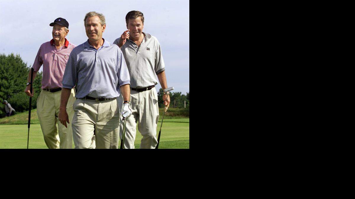 
In 2001, President Bush, center, walks off the 18th hole with his brother, then-governor Jeb Bush, right, and father, former President George H.W. Bush, left, at the Cape Arundel Golf Club in Kennebunkport, Maine, Saturday, July 7, 2001. The elder Bush is credited with putting a family priority on playing 18 holes quickly. 
