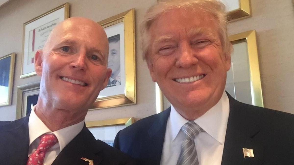 Florida Gov. Rick Scott poses with President-elect Donald Trump during a meeting at Trump Tower in New York in November