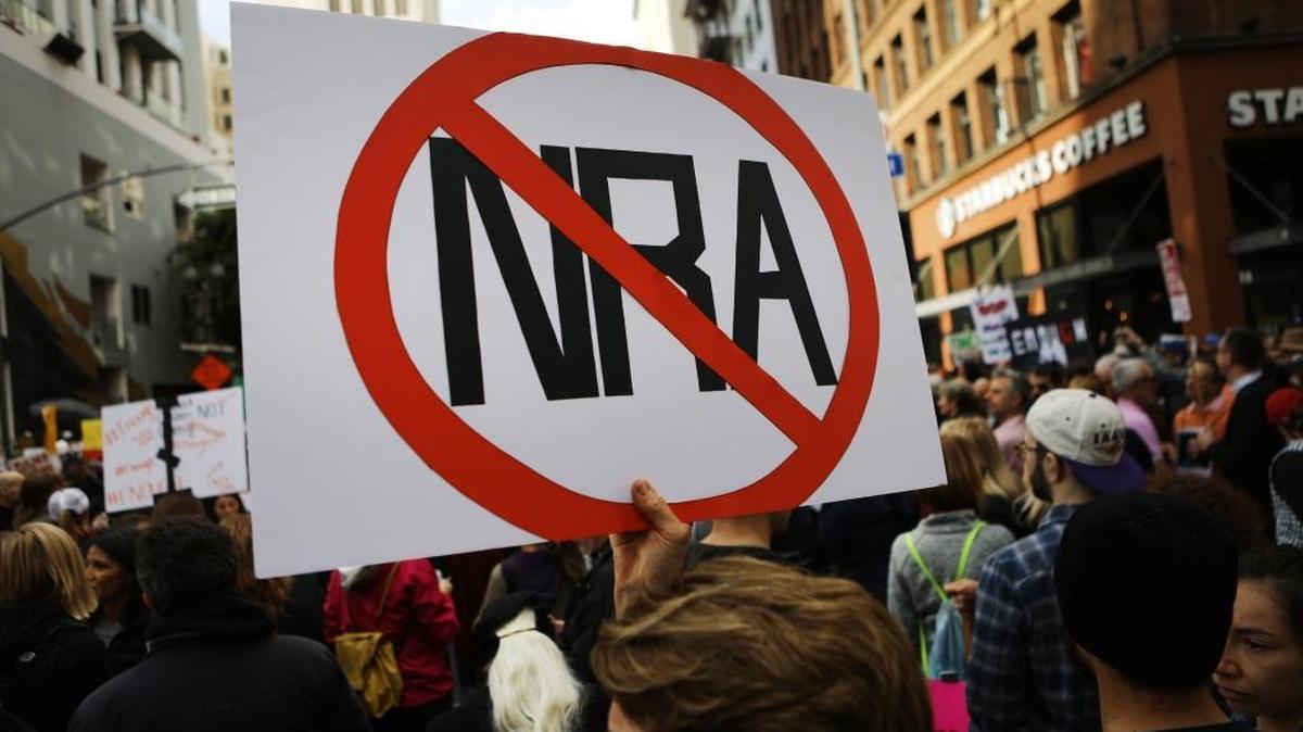 A protester holds an anti-NRA sign during the March for Our Lives rally on March 24, 2018, in Los Angeles.