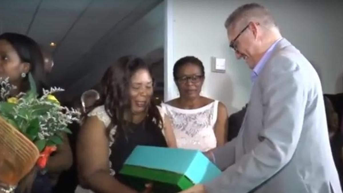 Sen. Daphne Campbell, center, accepts a gift from Julio C. Alfonso, founder of Solidaridad Sin Fronteras, during a May 24, 2017, birthday fundraiser at the Miami Shores Country Club.