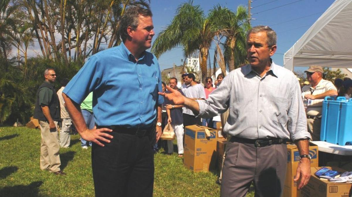 FILE--Florida Gov. Jeb Bush shakes hands with his brother, President George W. Bush, after short news conference during his visit Oct. 17, 2015, to Pompano Beach, Fla., to survey Hurricane Wilma damage.