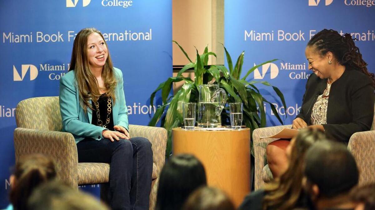 Chelsea Clinton, left, shares an upbeat moment with Pascale Charlot, dean of Miami Dade College's Honors College, during Clinton's visit to MDC's InterAmerican Campus in Miami on Thursday. Clinton visited the School of Education to discuss her book "It's your World: Get Informed, Get Inspired & Get Going!" Charlot asked Clinton questions drawn from those submitted in advance by MDC students.