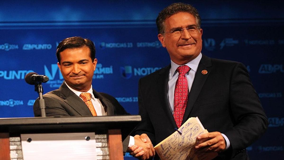 Carlos Curbelo and Joe Garcia shake hands at the end of a debate on October 21, 2014.