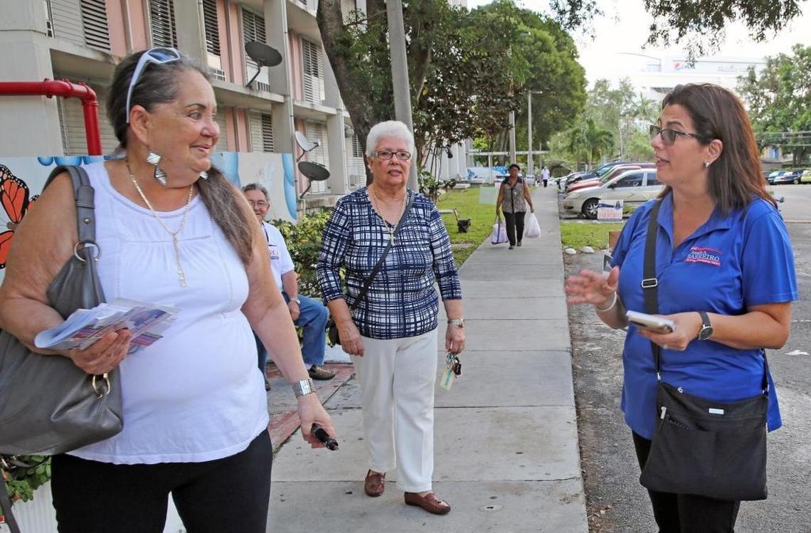Zoraida Barreiro, right, speaks to a potential voter while campaigning for a seat on the Miami City Commission last November. She finished third, and now is running to replace her husband, Bruno Barreiro, as a Miami-Dade commissioner in District 5.