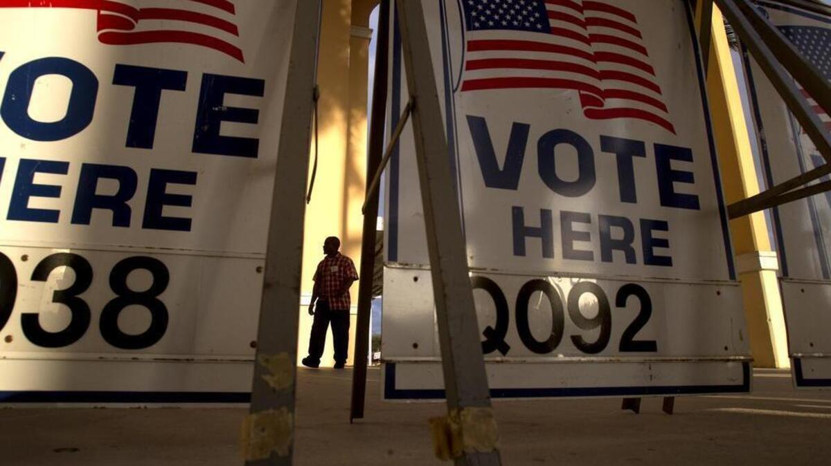 A voter arrives to vote in the Pembroke Pines municipal rlections and the Republican primary at the Broward County Southwest Regional Library, Tuesday Jan. 31, 2012.