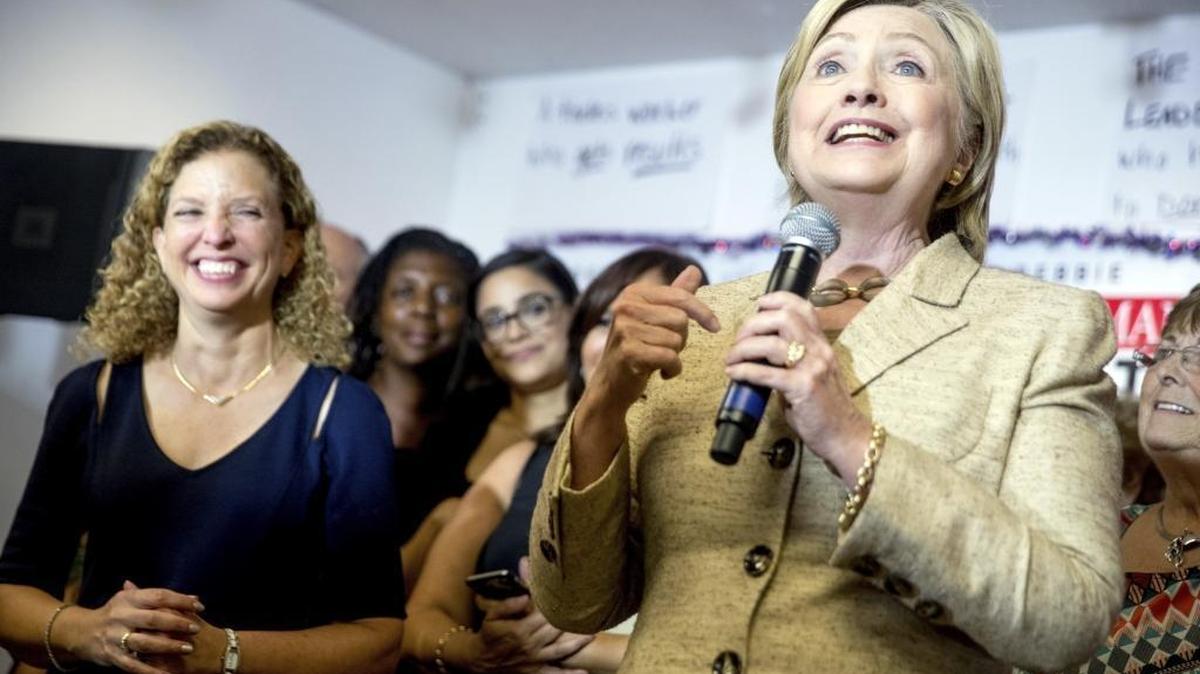 Democratic presidential candidate Hillary Clinton stops in to speak to workers at a campaign office for Rep. Debbie Wasserman Schultz, D-Fla., left, in Davie on Aug. 9.