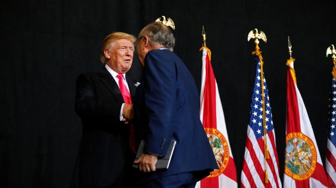 Republican presidential candidate Donald Trump arrives to speak at a campaign rally in Tampa on Wednesday. Left is former New York Mayor Rudy Giuliani.