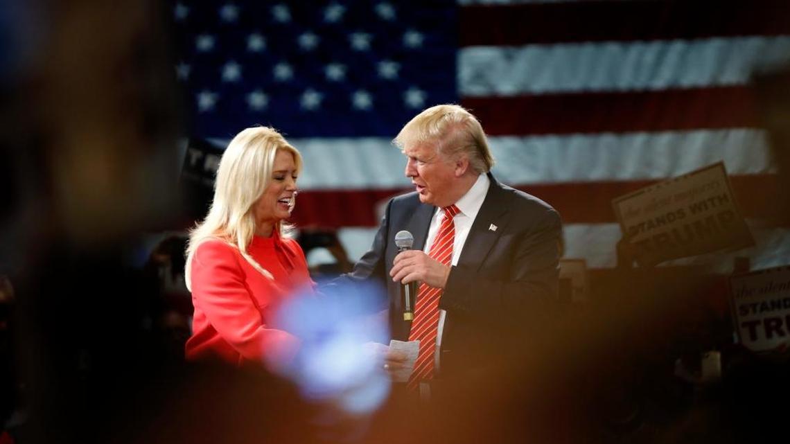 Republican presidential candidate Donald Trump is greeted by Florida Attorney General Pam Bondi as she introduces him to speak at a campaign event in Tampa. Bondi endorsed Trump as her choice to be the GOP candidate.