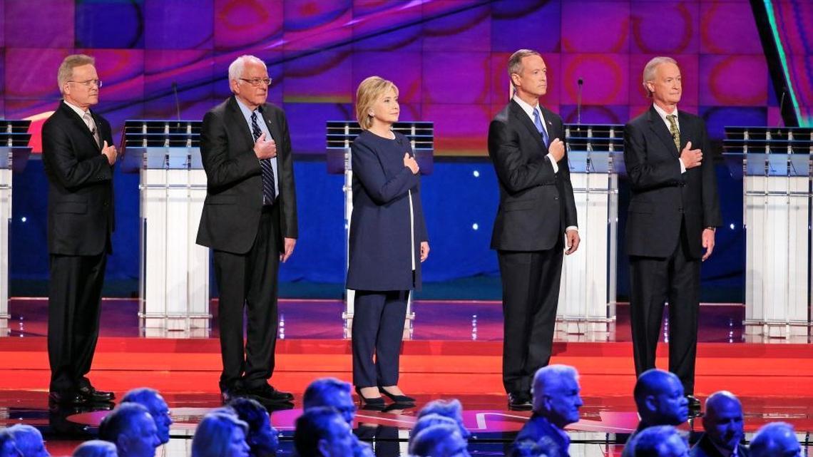 From left, Democratic presidential candidates former Virginia Sen. Jim Webb, Sen. Bernie Sanders of Vermont, Hillary Clinton, former Maryland Gov. Martin O'Malley and former Rhode Island Gov. Lincoln Chafee listen to the National Anthem before the CNN Democratic presidential debate on Tuesday in Las Vegas.