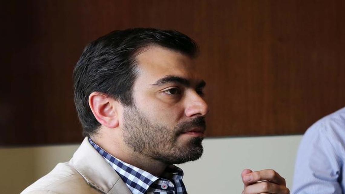 Freddy Balsera, left, pictured with a client, speaks to reporters in June.