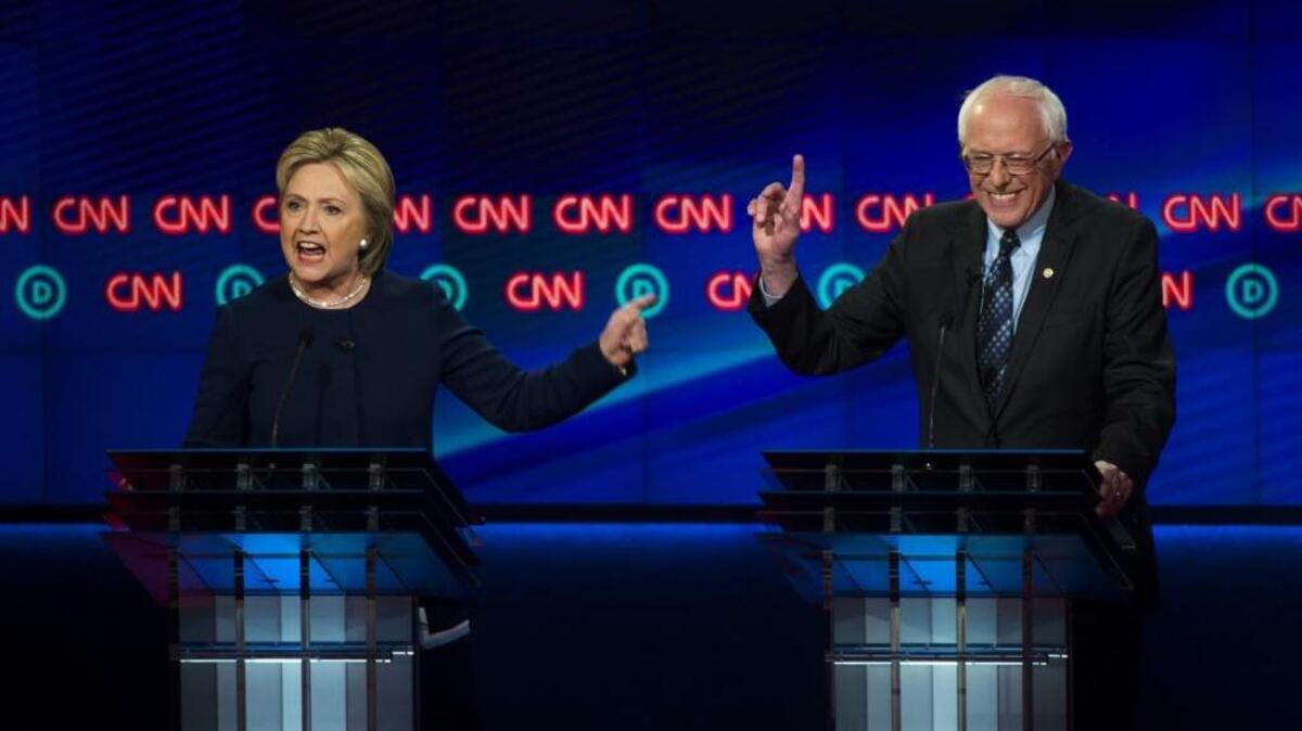Democratic presidential candidates Hillary Clinton and Bernie Sanders argue a point during the Democratic presidential primary debate at the University of Michigan-Flint on Sunday.