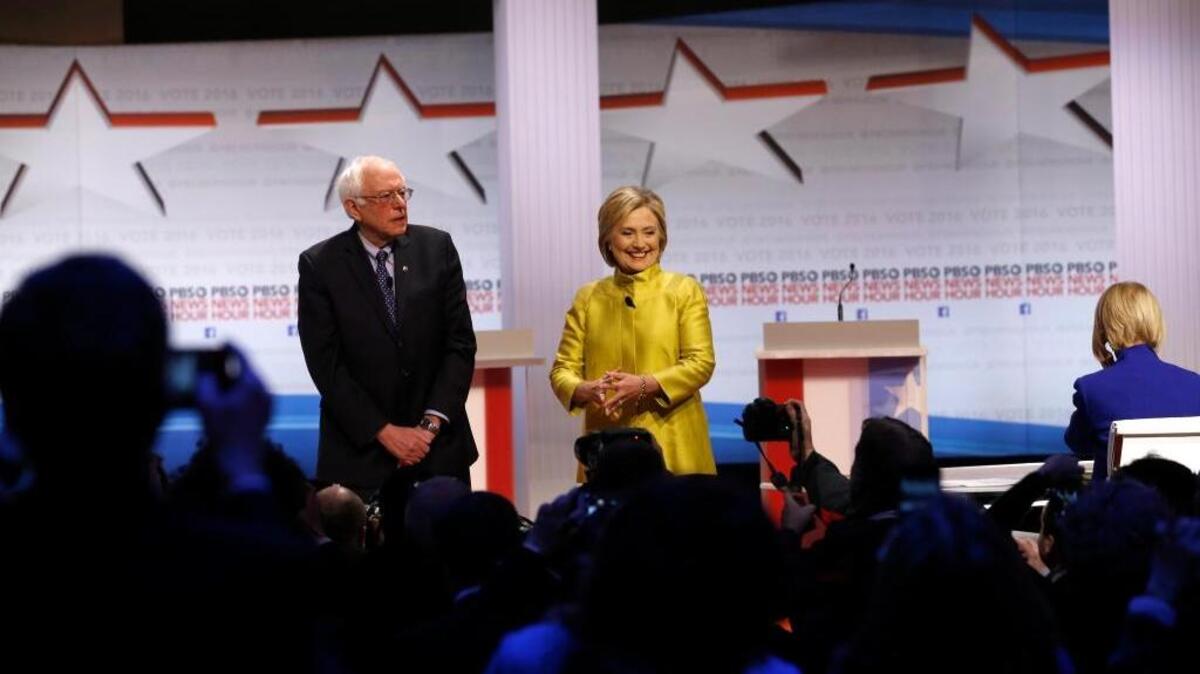Democratic presidential candidates Sen. Bernie Sanders, I-Vt, left, and Hillary Clinton take the stage before a Democratic presidential primary debate at the University of Wisconsin-Milwaukee, Friday, Feb. 12, 2016, in Milwaukee.