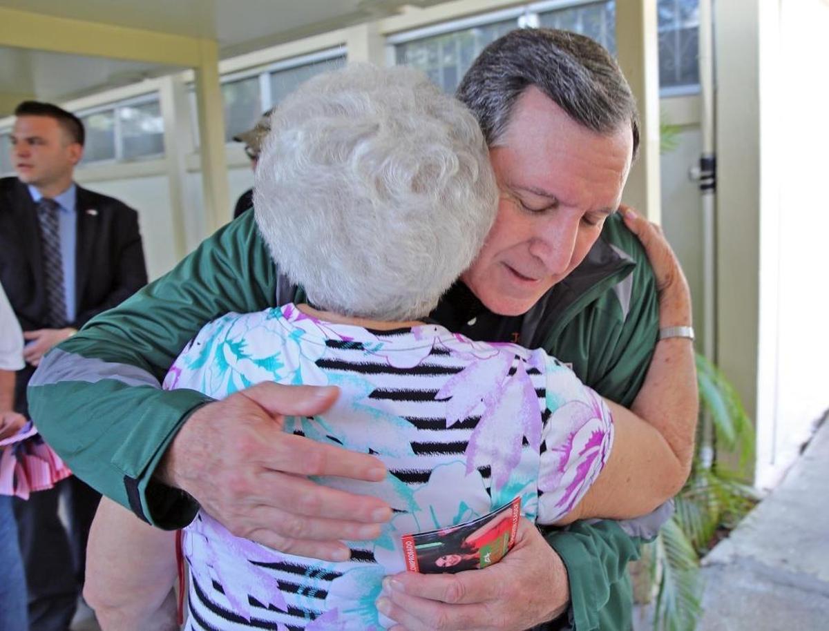 Miami Commission candidate Joe Carollo hugs a supporter at a voting precinct at Robert King High Tower in Miami on Tuesday, November 7, 2017.