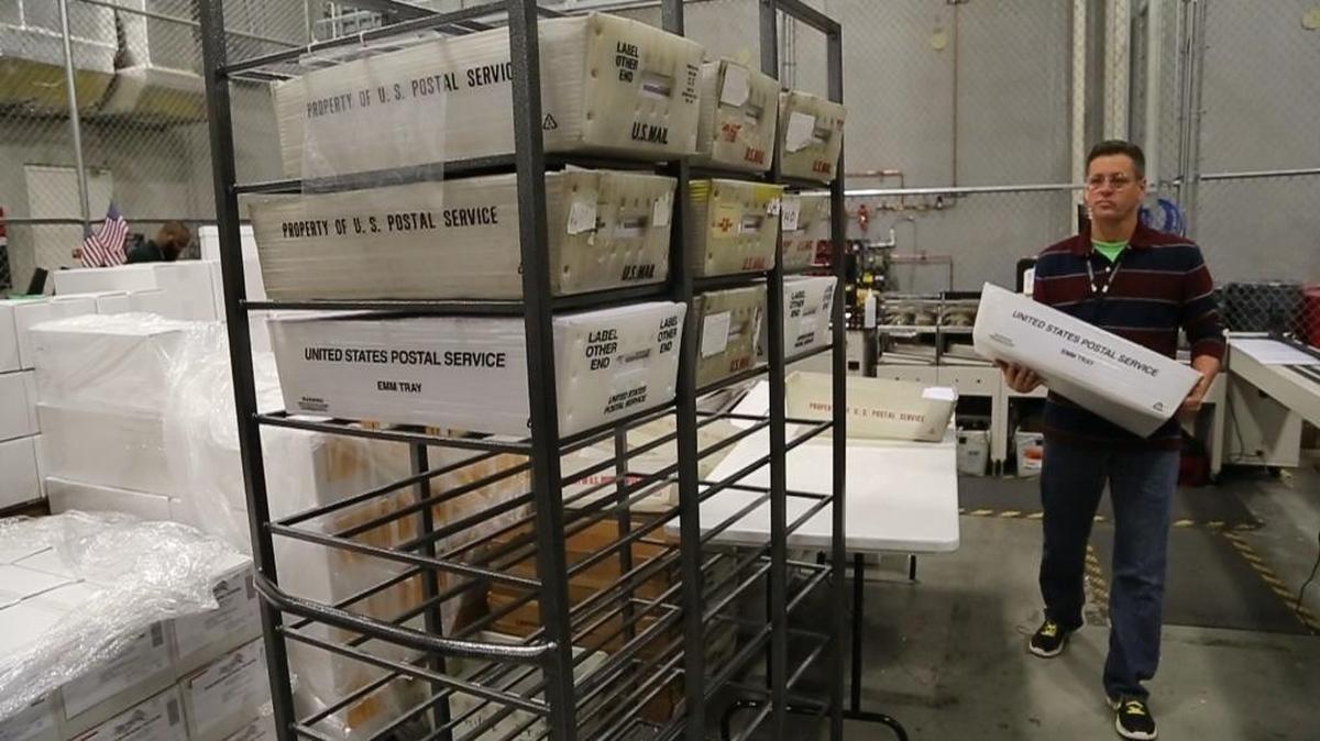 A worker at the Miami-Dade County Elections Department in Doral prepares ballots to be mailed to voters, February 1, 2016.