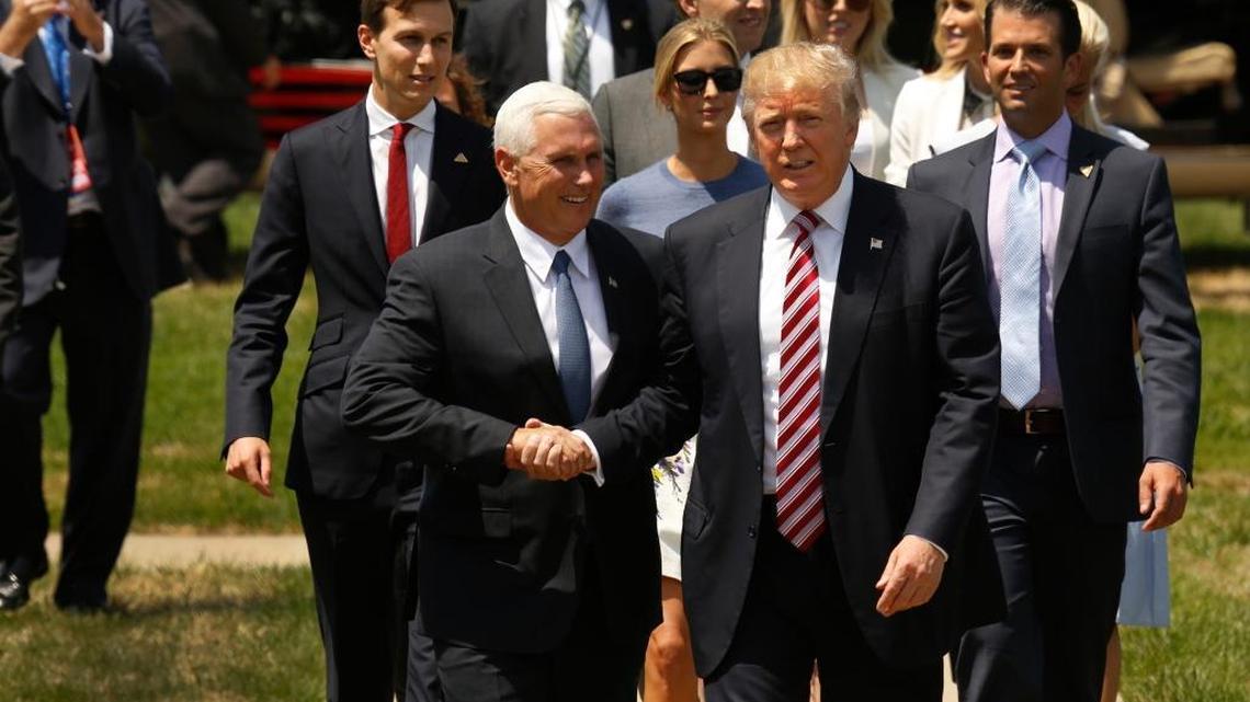 Republican presidential candidate Donald Trump is greeted by his running mate Mike Pence after arriving by helicopter at the Cleveland Science Center on Wednesday.