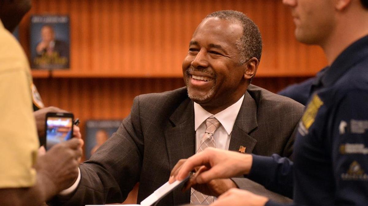 Republican presidential candidate Ben Carson smiles and shakes hands with local residents during his book signing event in The Villages in Florida on Monday.