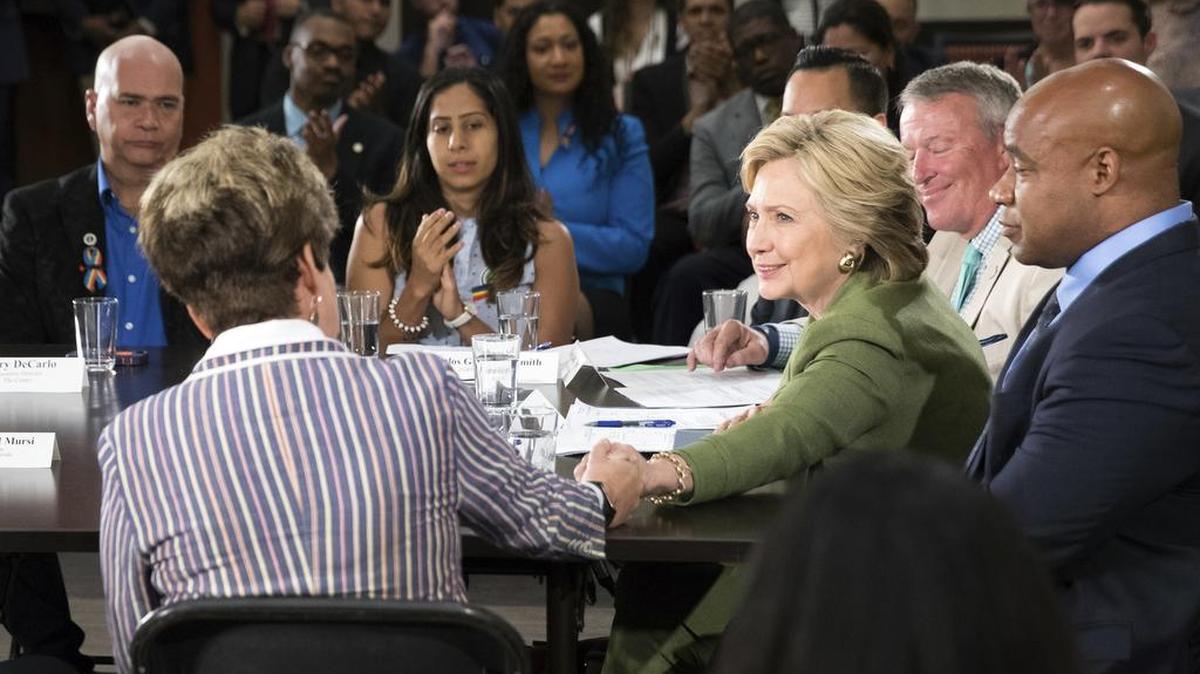 Democratic presidential candidate Hillary Clinton grips the hand of Orlando Commissioner Patty Sheehan as she becomes emotional while speaks at a roundtable with other community leaders at the Holden Heights Community Center in Orlando on Friday about the shooting attack on the Pulse nightclub.