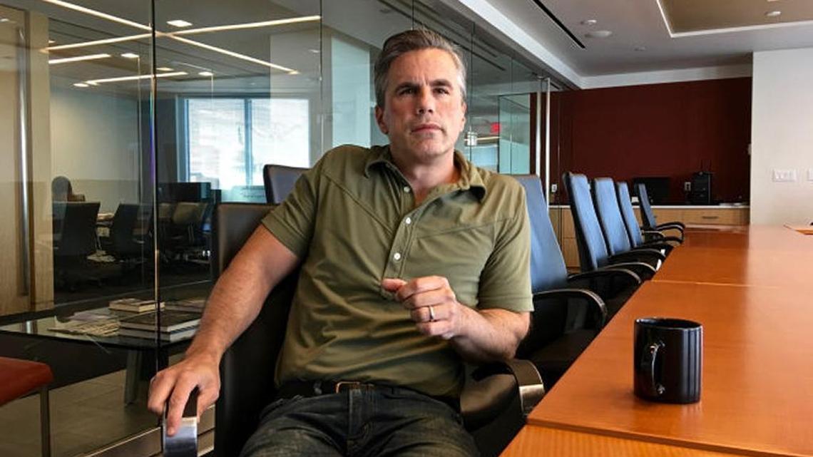 Tom Fitton, president of Judicial Watch, is pictured in the group's Washington office, the U.S. Capitol reflected in the background.
