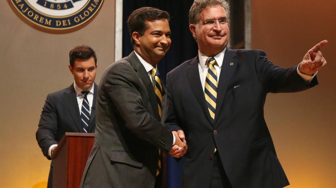 Miami Republican Rep. Carlos Curbelo, left, shakes hand with Democratic challenger and former Rep. Joe Garcia before their first debate Thursday at their shared alma mater, Belen Jesuit Preparatory School.