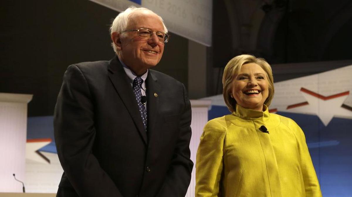 Democratic presidential candidates Sen. Bernie Sanders, I-Vt, left, and Hillary Clinton smile as they take the stage before a Democratic presidential primary debate at the University of Wisconsin-Milwaukee, Thursday, Feb. 11, 2016, in Milwaukee.