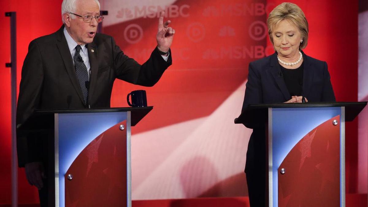 Democratic presidential candidate, Sen. Bernie Sanders, I-Vt, makes a point as Democratic presidential candidate, Hillary Clinton listens during a Democratic presidential primary debate hosted by MSNBC at the University of New Hampshire Thursday, Feb. 4, 2016, in Durham, N.H.