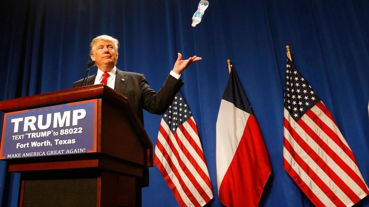 Donald Trump tosses a water bottle while speaking to supporters about Marco Rubio during a rally at the Fort Worth Convention Center in Texas on Friday.