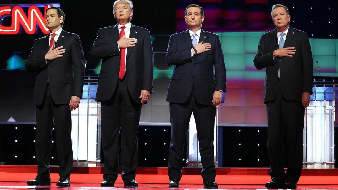 Republican presidential candidates Marco Rubio, Donald Trump, Ted Cruz and John Kasich stand up for the national anthem during the Republican presidential primary debate at the University of Miami on March 10, 2016.