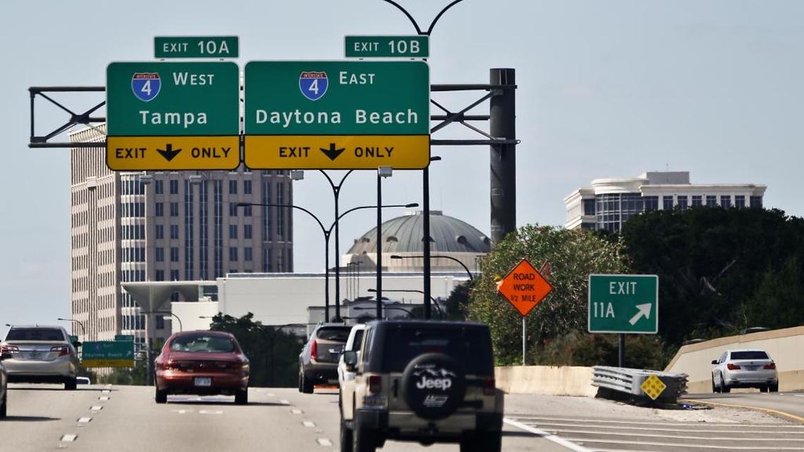 In this Wednesday, Oct. 26, 2016 photo, signs in Orlando direct motorists to Tampa and Daytona Beach, the Intestate 4 corridor, a strategic region in politics, due to the large number of undecided voters in the state.
